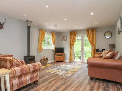a living room with two couches and a fireplace at Park Brook Dell in Preston