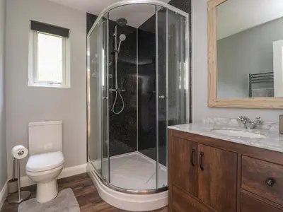 a bathroom with a shower with a toilet and a sink at Park Brook Dell in Preston