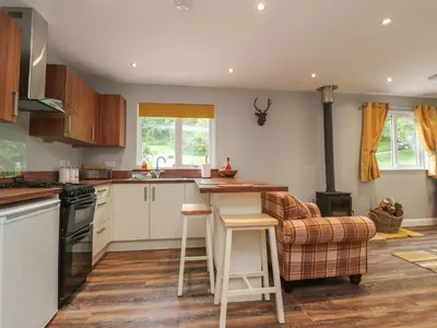 a kitchen with white cabinets and a counter top at Park Brook Dell in Preston