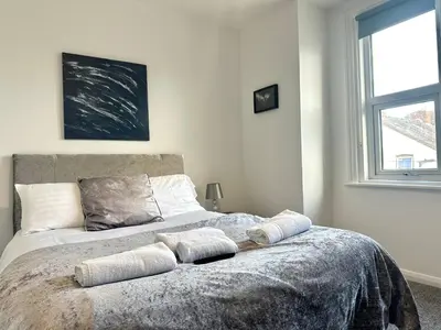 a bedroom with a bed with two pillows on it at Sienna Family Holiday Apartments by Blackpool Service Apartments in Blackpool