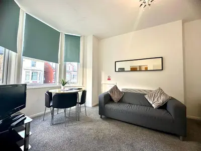 a living room with a couch and a table at Sienna Family Holiday Apartments by Blackpool Service Apartments in Blackpool