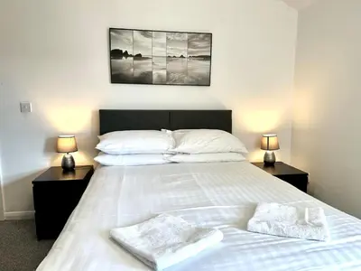 a bedroom with a bed with two towels on it at Sienna Family Holiday Apartments by Blackpool Service Apartments in Blackpool