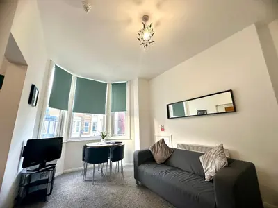 a living room with a couch and a table at Sienna Family Holiday Apartments by Blackpool Service Apartments in Blackpool