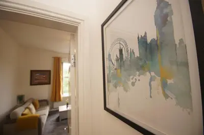 a painting hanging on a wall in a living room at Grosvenor Lodge Birkdale Southport in Southport