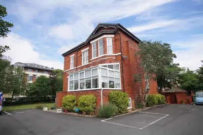 a red brick building with a lot of windows at Grosvenor Lodge Birkdale Southport in Southport