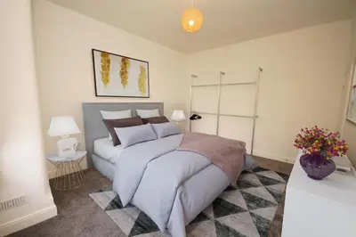 a bedroom with a large bed in a room at Grosvenor Lodge Birkdale Southport in Southport