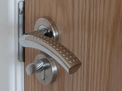 a metal door handle on a wooden door at Langtrys in Blackpool