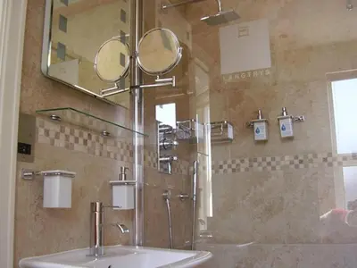 a bathroom with a sink and a mirror at Langtrys in Blackpool