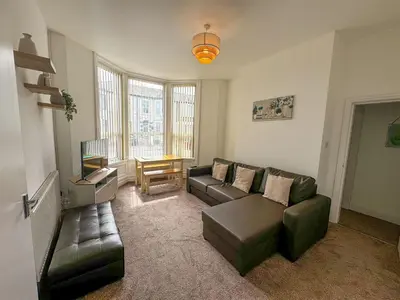 a living room with a couch and a table at Cherry Property - Pear Suite in Blackpool