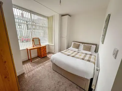 a small bedroom with a bed and a window at Cherry Property - Pear Suite in Blackpool