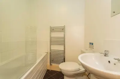 a bathroom with a toilet and a sink and a tub at Cherry Property - Pear Suite in Blackpool