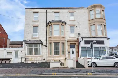 a white car parked in front of a building at Cherry Property - Pear Suite in Blackpool