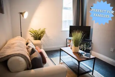 a living room with a couch and a coffee table at Buchanan House Sasco Apartments in Blackpool