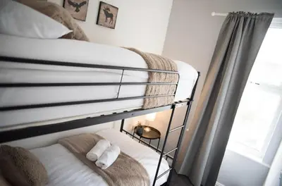 a bunk bed with two towels on the bottom bunk at Buchanan House Sasco Apartments in Blackpool