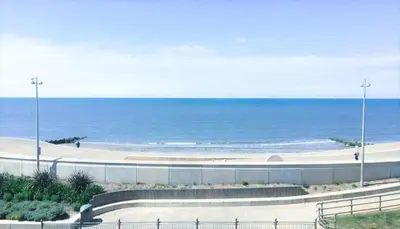 a sandy beach with the ocean in the background at Seahawk Holiday Apartments in Cleveleys