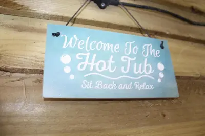 a sign that says welcome to the hot tubhit back and relax at Albert Hottub & Jacuzzi Apartments in Blackpool