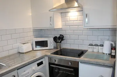 a kitchen with a sink and a microwave at Albert Hottub & Jacuzzi Apartments in Blackpool
