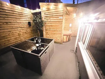 a teddy bear sitting in a box in a room at Albert Hottub & Jacuzzi Apartments in Blackpool