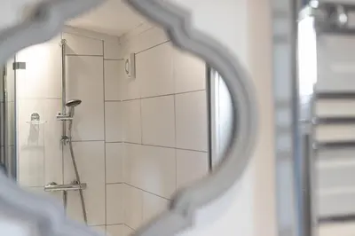 a shower in a bathroom with a mirror at Inside No. 1 Retreat in Carnforth