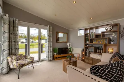 a living room with a couch and a tv at Inside No. 1 Retreat in Carnforth