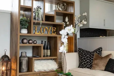 a living room with a couch and wooden shelves at Inside No. 1 Retreat in Carnforth