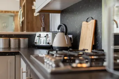 a kitchen counter with a tea kettle on the stove at Inside No. 1 Retreat in Carnforth