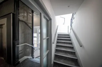 a staircase in a building with a glass door at 16 Queen Avenue Collection by Happy Days in Liverpool