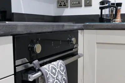 a towel is hanging from an oven in a kitchen at 16 Queen Avenue Collection by Happy Days in Liverpool