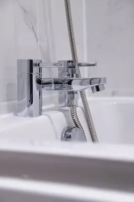 a sink with a faucet in a bathroom at 16 Queen Avenue Collection by Happy Days in Liverpool