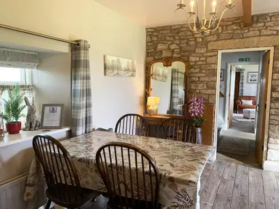 a dining room with a table and chairs at Cuthbert Hill Farm in Preston