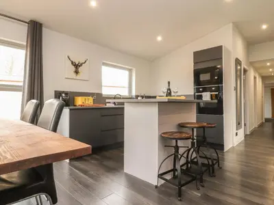 a kitchen and dining room with a table and chairs at Box Tree Escapes in Lancaster