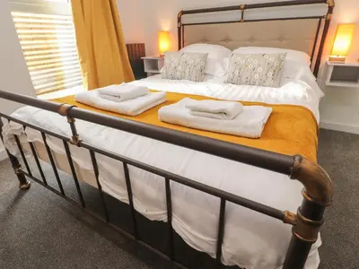 a bedroom with a bed with towels on it at Box Tree Escapes in Lancaster