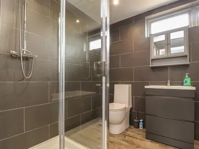 a bathroom with a shower and a toilet and a sink at Box Tree Escapes in Lancaster
