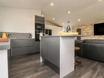 an open kitchen and living room with a counter top at Box Tree Escapes in Lancaster