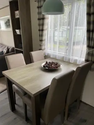 a dining room table with chairs and a bowl of food on it at lake view staycations in Carnforth
