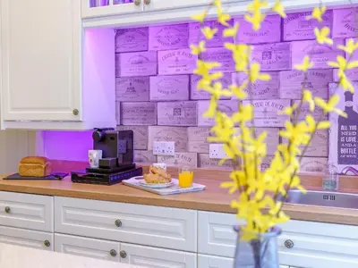 a kitchen with a purple wall with writing on it at The Kings Landing Spa in Blackpool