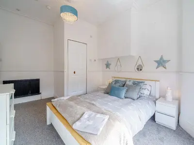 a bedroom with a bed with stars on the wall at The Kings Landing Spa in Blackpool
