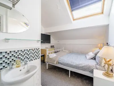 a bedroom with a bed and a sink and a mirror at The Kings Landing Spa in Blackpool
