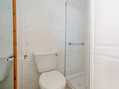 a bathroom with a toilet and a glass shower at The Kings Landing Spa in Blackpool