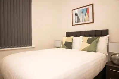 a bedroom with a white bed and a window at Lord Street Apartments By Happy Days in Liverpool