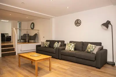a living room with a couch and a table at Lord Street Apartments By Happy Days in Liverpool