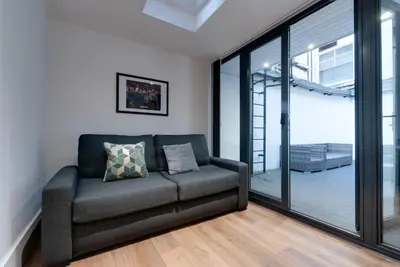 a living room with a couch and sliding glass doors at Lord Street Apartments By Happy Days in Liverpool