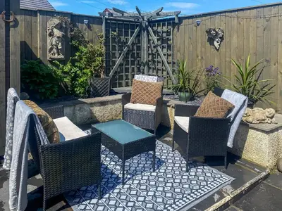 a patio with chairs and a table and a fence at Wild Duck in Pennington