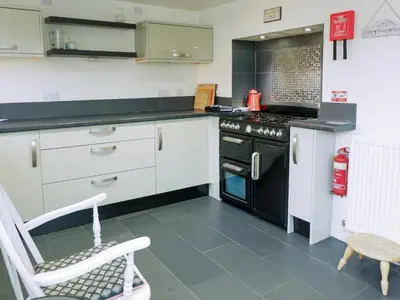a kitchen with white cabinets and a black stove at Wild Duck in Pennington