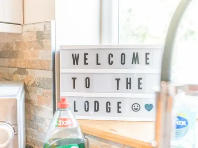 a welcome to the lodge sign in a kitchen at The Lodge in Dalton in Furness