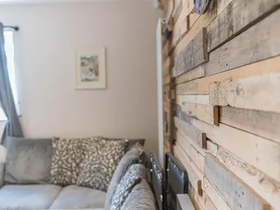 a living room with a brick wall and a couch at The Lodge in Dalton in Furness
