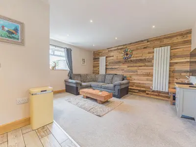 a living room with a couch and a table at The Lodge in Dalton in Furness