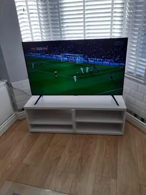 a flat screen tv sitting on a white stand in a room at Hanwell House in Liverpool