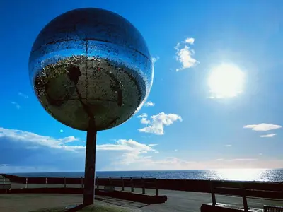 a large globe on a pole next to the ocean at Chelsea Suite Sasco Apartments in Blackpool