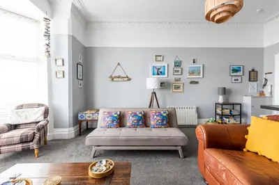 a living room with a couch and a chair at Beach Shore - SEA VIEWS in Lytham St Annes
